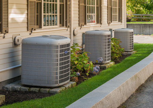 3 outdoor AC units in front of their respective Wausau, WI, homes.