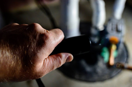 Homeowner plugging in sump pump.