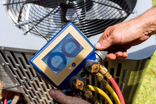 A technician performing a service on an outdoor AC unit.
